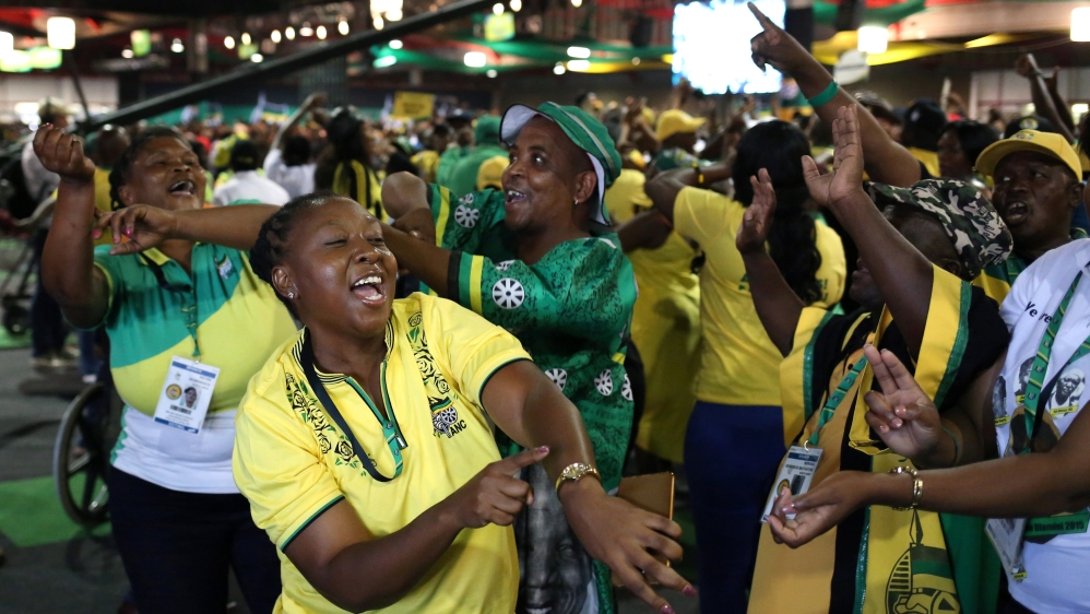 ANC members celebrate after the announcement of the results [Siphiwe Sibeko/Reuters]