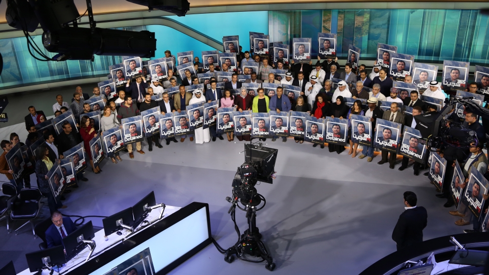 Al Jazeera journalists held a silent solidarity protest on December 20 to mark their colleague's year in jail [Showkat Shafi/Al Jazeera]