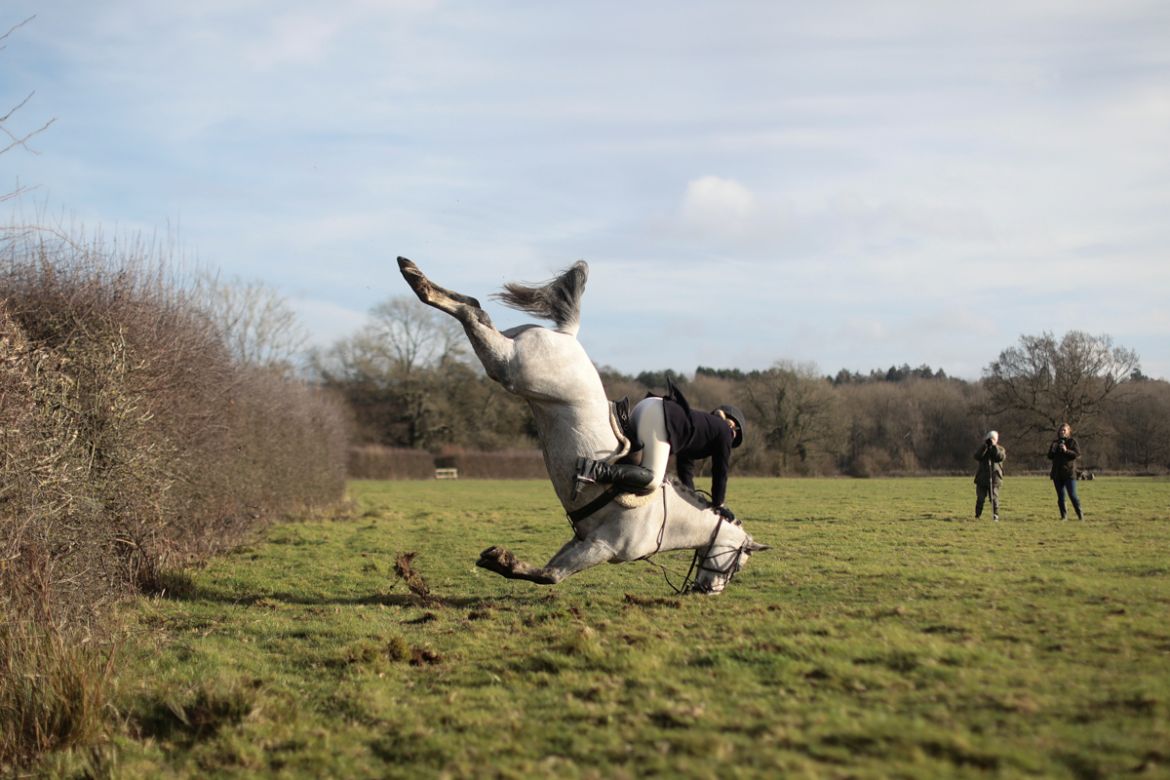 A member of the Old Surrey Burstow and West Kent Hunt crashes as she jumps a fence during the annual Boxing Day hunt in Chiddingstone, Britain December 26, 2017. REUTERS/Simon Dawson TPX IMAGES OF THE