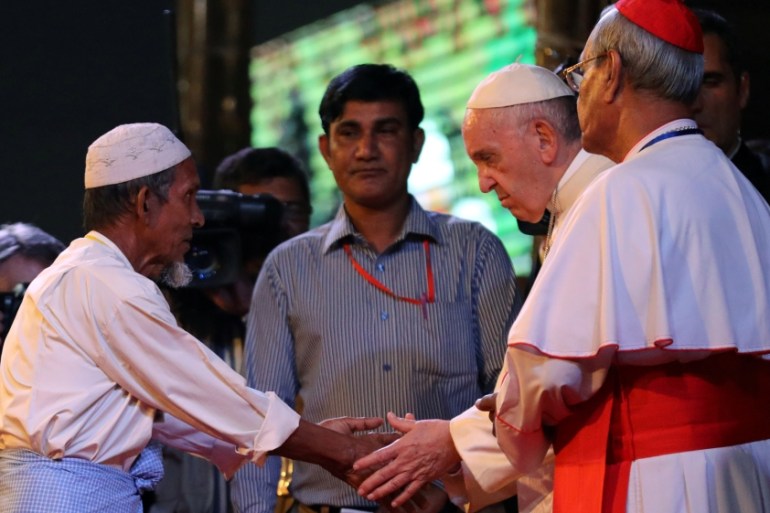 Pope Francis shakes hands with a Rohingya refugee during an inter-religious conference at St Mary’s Cathedral in Dhaka