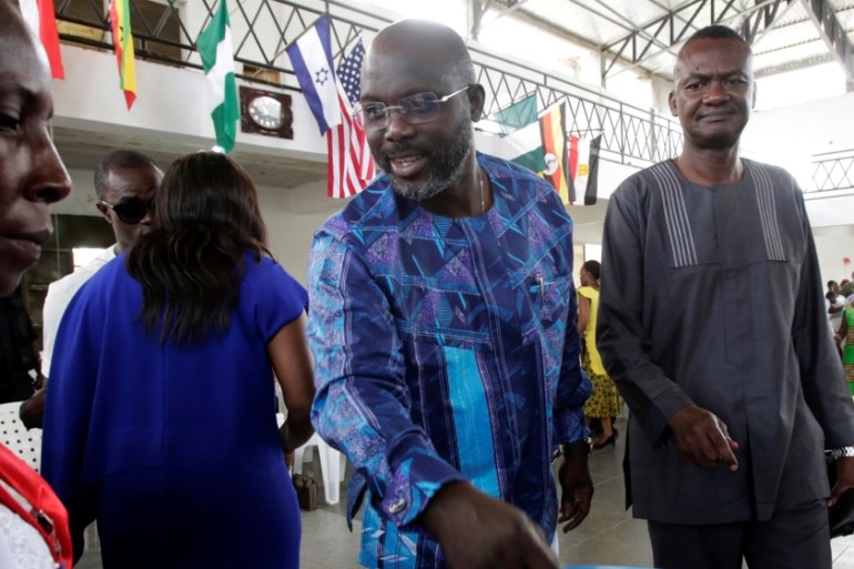George Weah, former soccer player and presidential candidate of Congress for Democratic Change (CDC), votes at a polling station in Monrovia