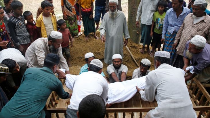 Rohingya refugees carry the body of Rostom Ali, 80, who died of an illness, at his grave during his burial at Balu Khali refugee camp near Cox''s Bazar, Bangladesh