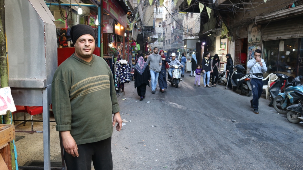 Mohamad Jabbar makes as little as $10 a day at his butcher shop, just a tenth of what he could earn if Palestinians were allowed to open businesses outside camps [Lisa Khoury/Al Jazeera]