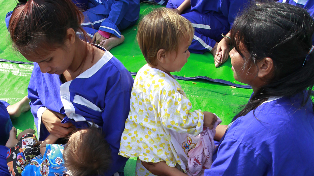 Female prisoners look after their children during a meeting at Prey Sar in Phnom Penh in 2015 [File: Mak Remissa/EPA]