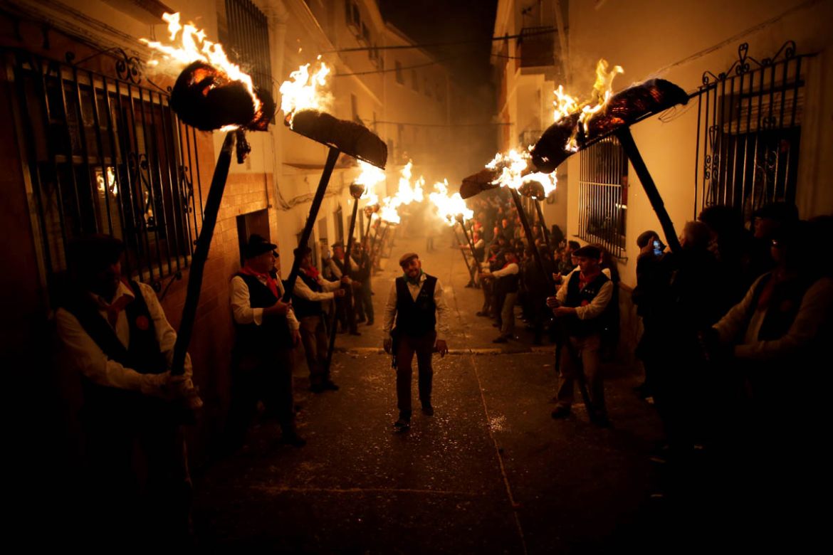 Villagers hold torches to represent light and vision during the Divina Pastora procession, as part of a festival to honour the Virgin of Los Rondeles, on the eve of St Lucia''s Day, in Casarabonela, ne
