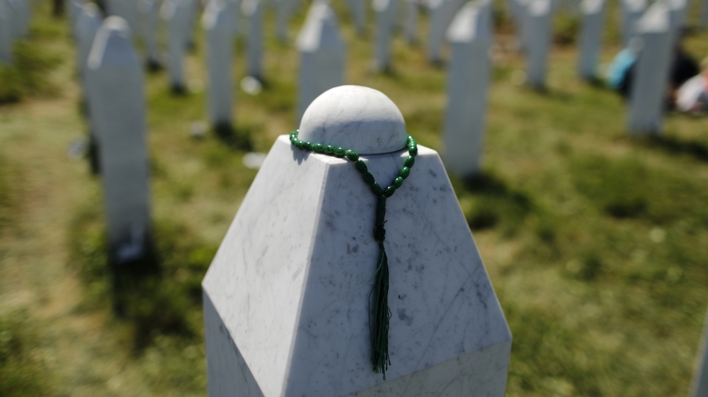 A rosary is placed on a tombstone at the Memorial Center Potocari, near Srebrenica [File: Antonio Bronic/Reuters]