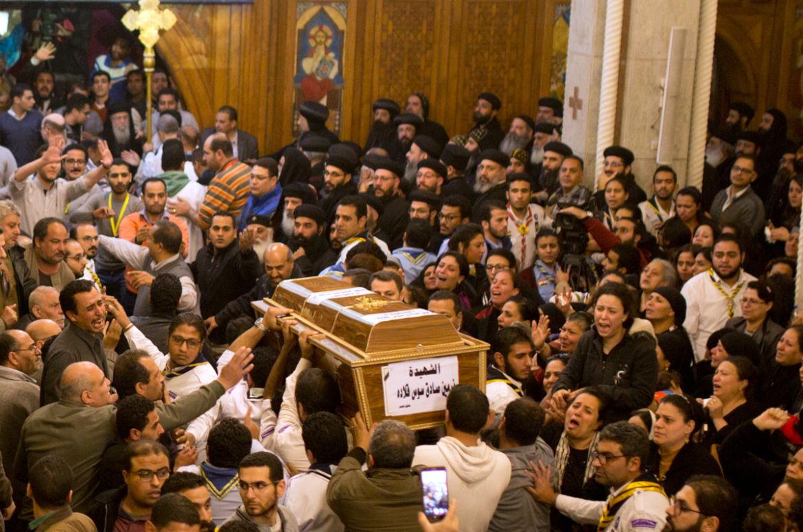 Relatives of Coptic Christians grieve as they carry the coffin of Nermin Sadek, one of the victims of the militants attack on Mar Mina church, during their funeral service in Cairo, Egypt, Friday, Dec