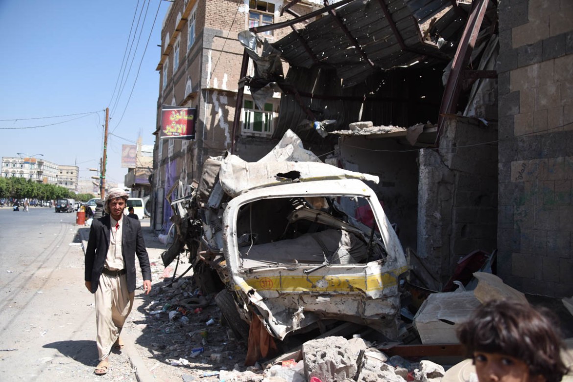 A man walks by civilian houses destroyed in Sana’a. Destruction in the Yemeni capital is everywhere: houses, health centres, wedding halls and even children’s playgrounds have been targeted by the air