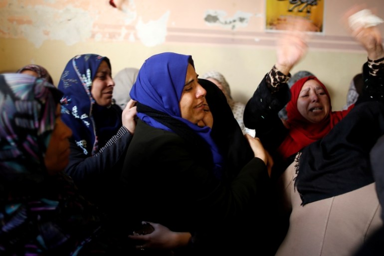 Relatives of Palestinian Mesleh, who died of his injuries during clashes with Israeli troops on Friday, mourn during his funeral in the central Gaza Strip