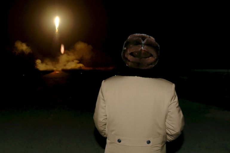 Kim watching missiles Reuters