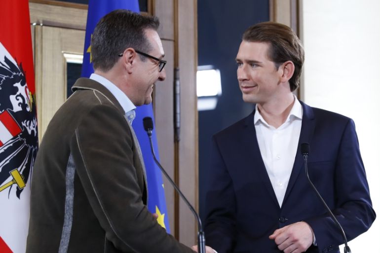 Head of the FPOe Strache and head of the OeVP Kurz shake hands at the end of a news conference in Vienna