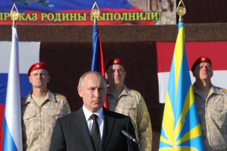 Russian President Putin addresses servicemen as he visits the Hmeymim air base in Latakia Province