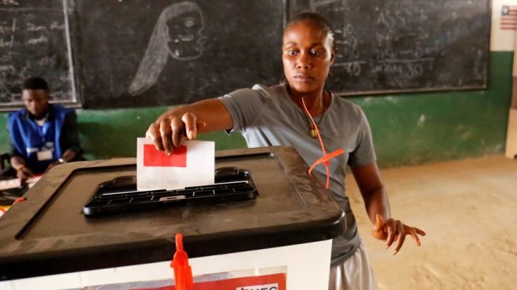 A woman casts her ballot during presidential elections at a polling station in Monrovia
