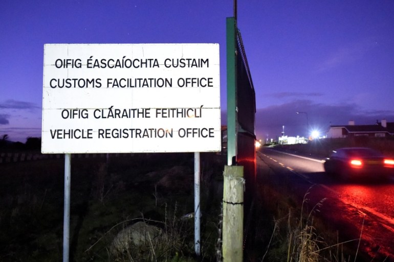 An old sign is seen at a disused customs post for a Customs Facilitation office and Vehicle Registration Office on the border town of Carrickcarnon