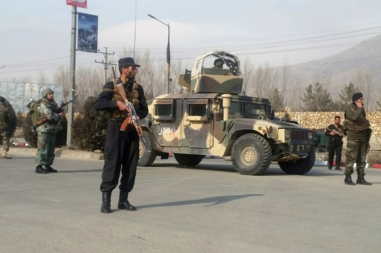 Afghan security forces keep watch at the site of an attack in Kabul, Afghanistan