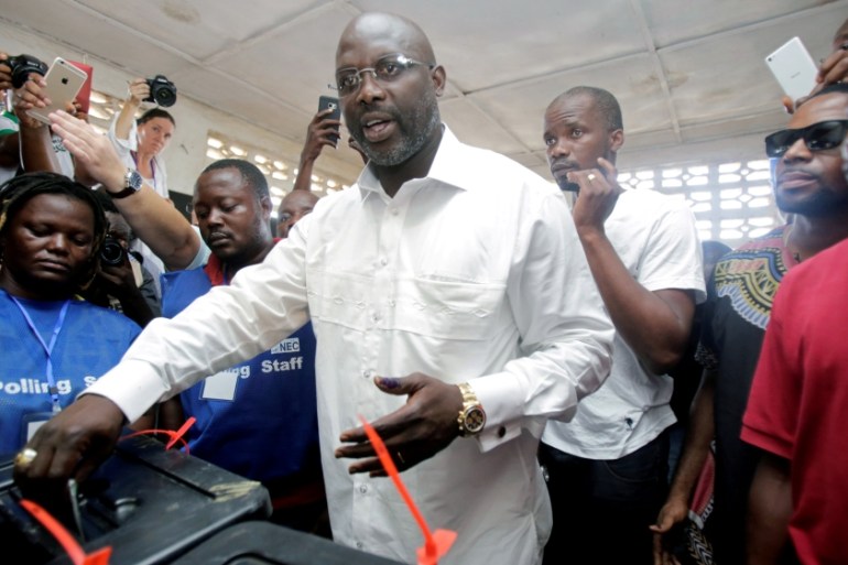 George Weah, former soccer player and presidential candidate of Congress for Democratic Change (CDC), votes at a polling station in Monrovia, Liberia, October 10, 2017
