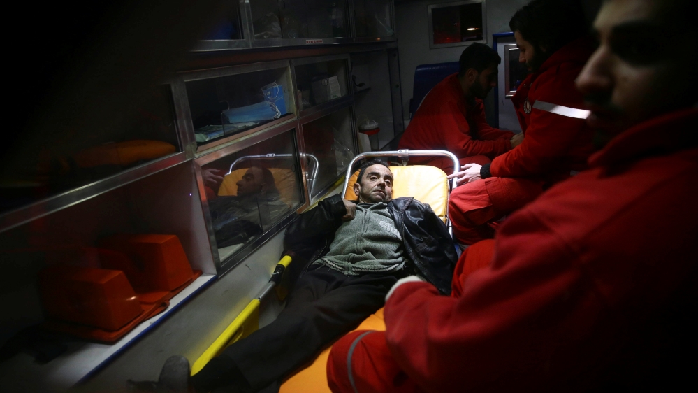 A man is seen in an ambulance during medical evacuation from the besieged town of Douma, eastern Ghouta [Reuters]