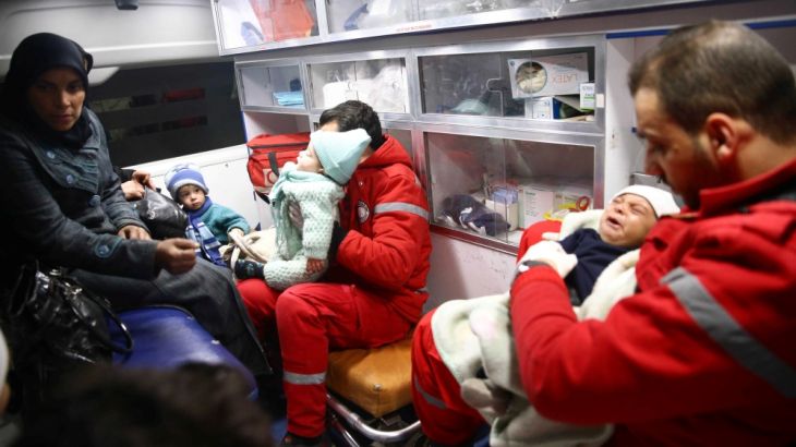 Woman is seen with her children in an ambulance during medical evacuation from the besieged town of Douma, Eastern Ghouta