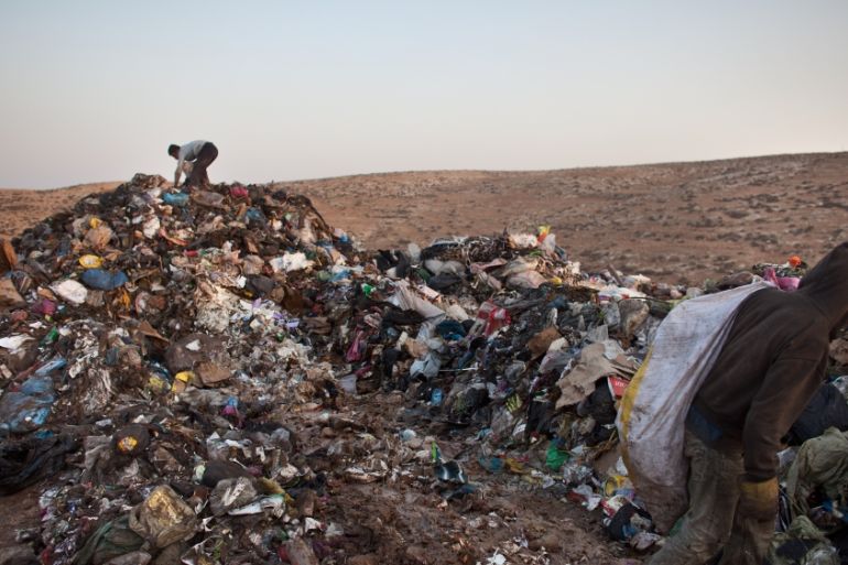 Palestinian Children Scavenge Through Settlement Garbage