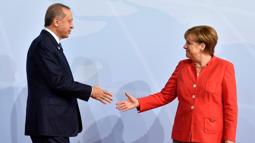 German Chancellor Angela Merkel greets Erdogan at the G20 summit in Hamburg in July [File: John MacDougall/Reuters] 