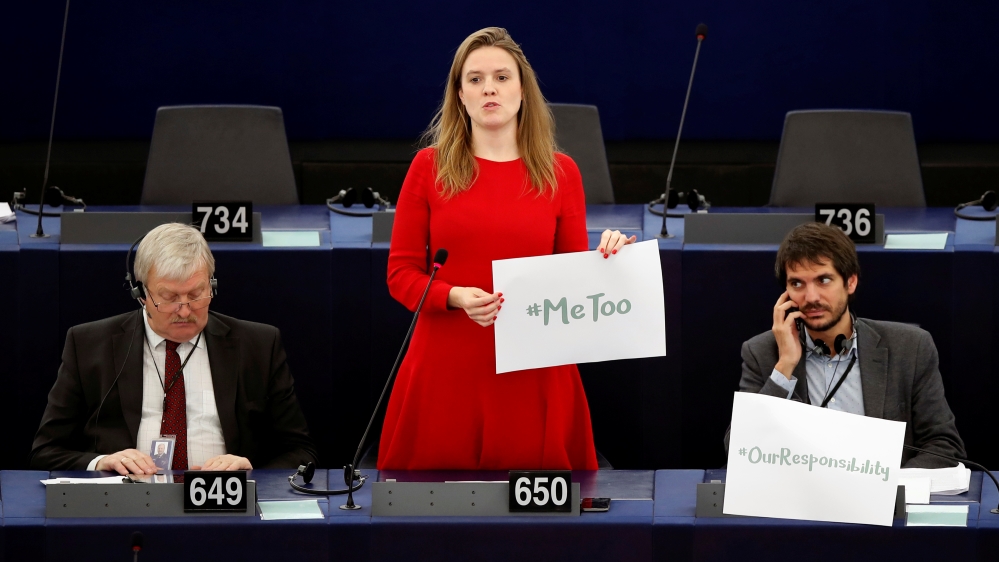 European Parliament member Terry Reintke holds a #MeToo placard in October [Christian Hartmann/Reuters]