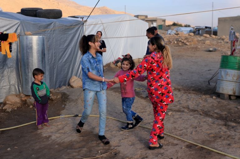 Yazidi girls who were reunited with their family after being enslaved by IS play at Sharya Camp in Duhuk