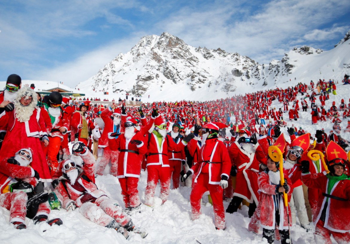 People dressed as Santa Claus enjoy the snow during the Saint Nicholas Day at the Alpine ski resort of Verbier, Switzerland. [Denis Balibouse/Reuters]