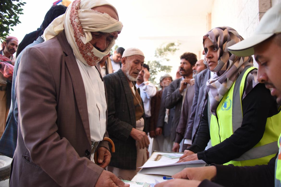 Yemenis queue at a food voucher distribution point in Sana’a. The Norwegian Refugee Council is helping some of the hardest hit families with food vouchers and other assistance. A staggering 8.4 mill