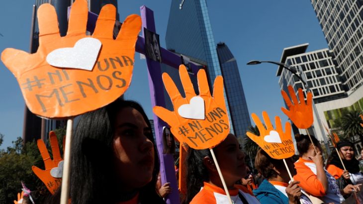 Demonstrators and relatives of women who were either murdered or disappeared take part in a march during the International Day for the Elimination of Violence Against Women in Mexico City