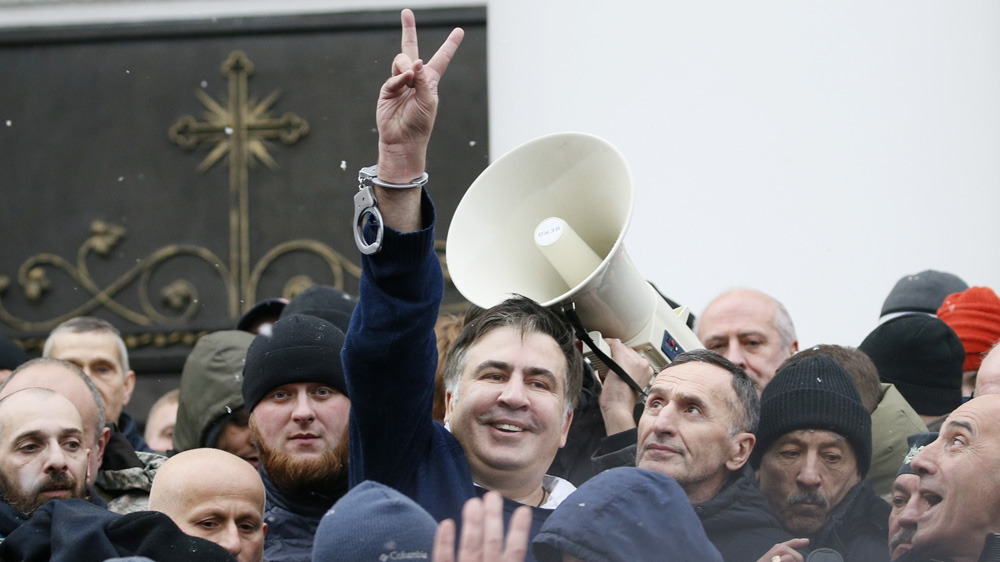 Saakashvili flashes a victory sign after he was freed by his supporters [Gleb Garanich/Reuters]