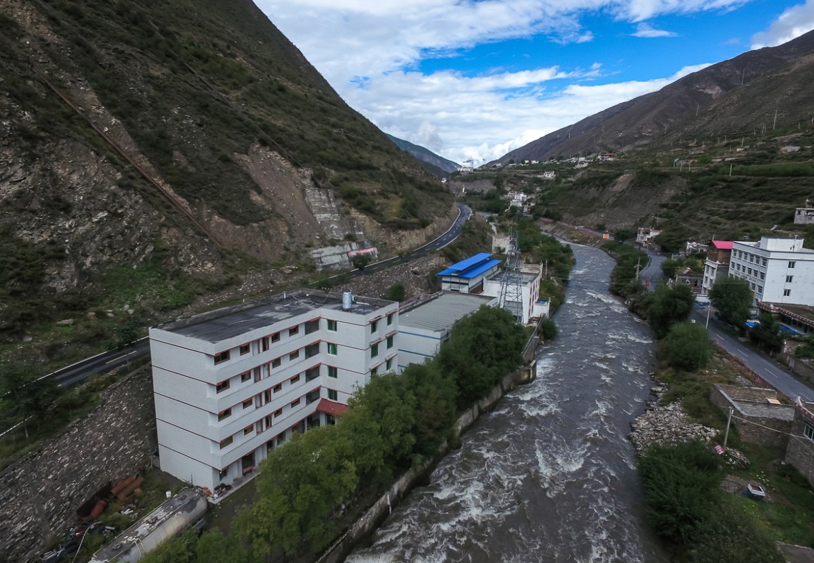 A Bitcoin ''mine'' with a blue tin roof sits next to a hydroelectric power plant in Ngawa (Aba) Tibetan and Qiang Autonomous Prefecture, Sichuan province, China, 27 September 2016. Located at the easter