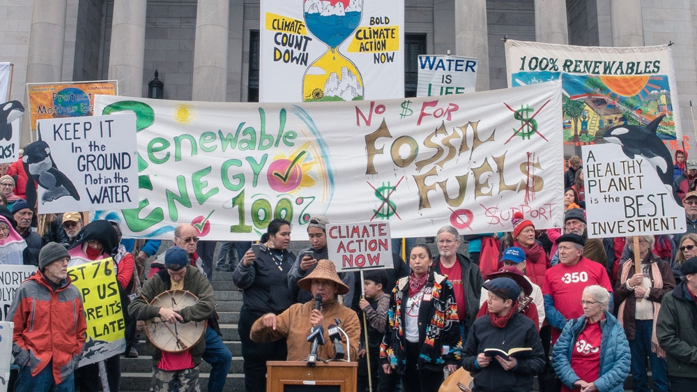 Climate activists also disrupted the opening session of the legislature [Austin Smith/Courtesy of 350 Seattle] 