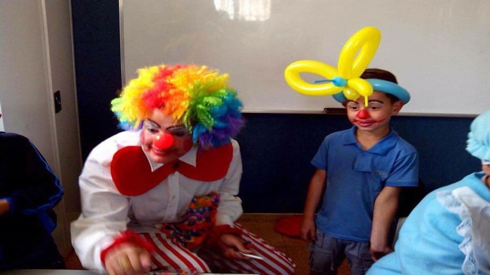 Israa Jaabis used to volunteer at schools and dress up as a clown to entertain children in hospitals [Palestine Post/Twitter] 