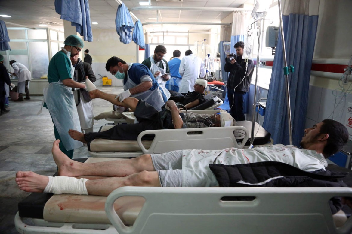 Injured men receive treatment at a hospital after a suicide attack in Kabul, Afghanistan, Saturday Jan. 27, 2018. A suicide car bomber killed at least 40 people and wounded about 140 more in an attack