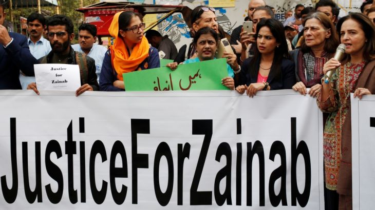 People hold signs to condemn the rape and killing of 7-year-old girl Zainab Ansari in Kasur, during a protest in Karachi, Pakistan