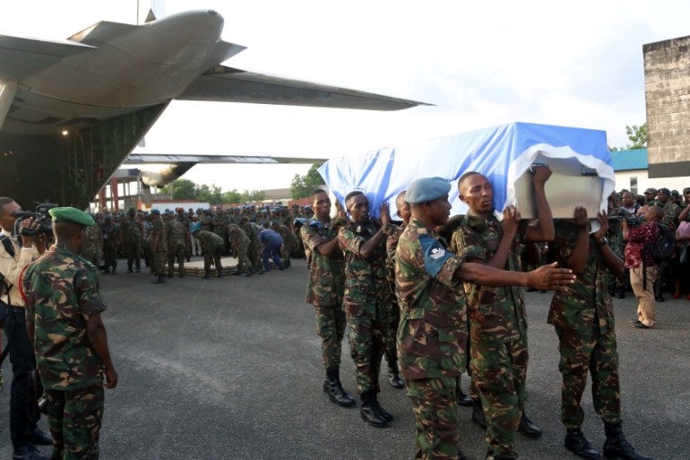 Tanzanian soldiers receive the bodies of their peacekeepers killed while serving in the United Nations Organization Stabilization Mission in the Democratic Republic of the Congo