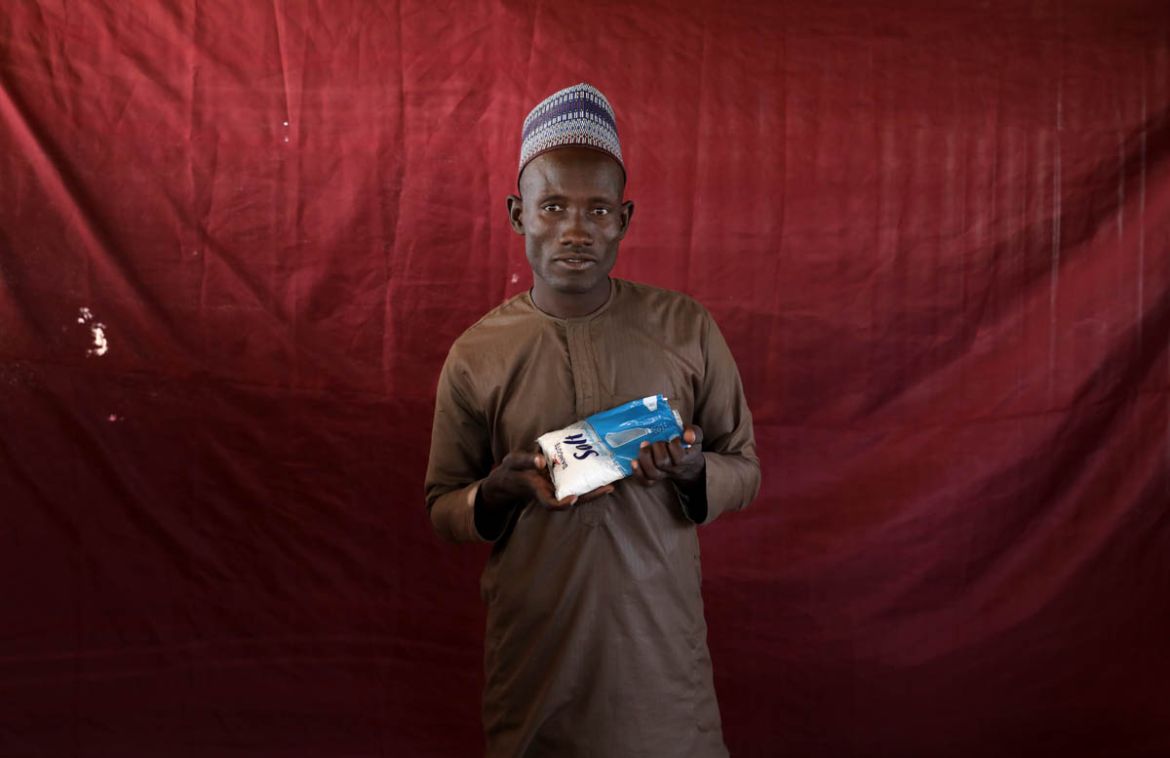 Insua Damladi holds up a sachet of salt. REUTERS/Afolabi Sotunde