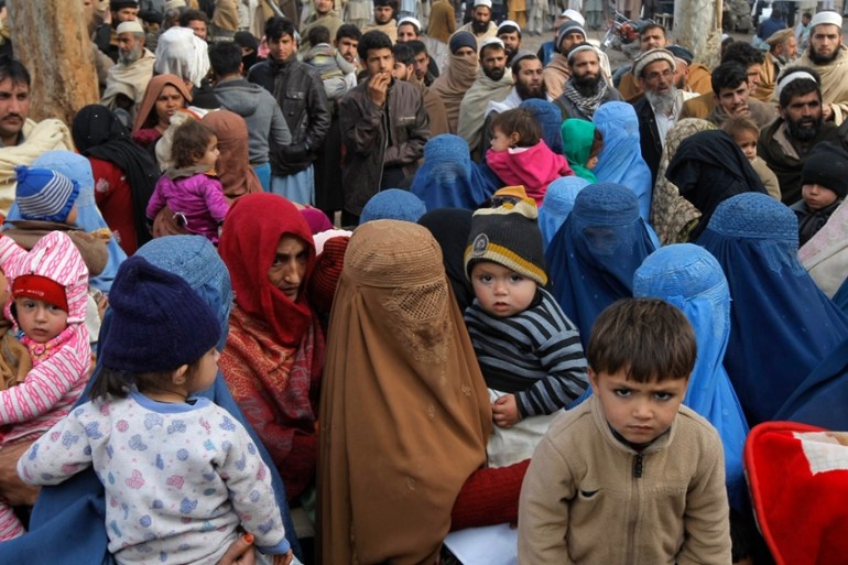 PAKISTAN AFGHAN REFUGEES .. In this picture taken on Wednesday, Feb. 8, 2017, Afghan refugee families wait for their turn to be registered, outside the government registration