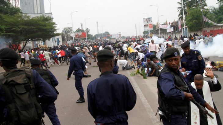Riot policemen fire teargas canisters to disperse demonstrators during a protest organised by Catholic activists in Kinshasa