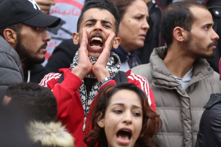 Demonstrating graduate shouts slogans during protests against rising prices and tax increases, in Tunis
