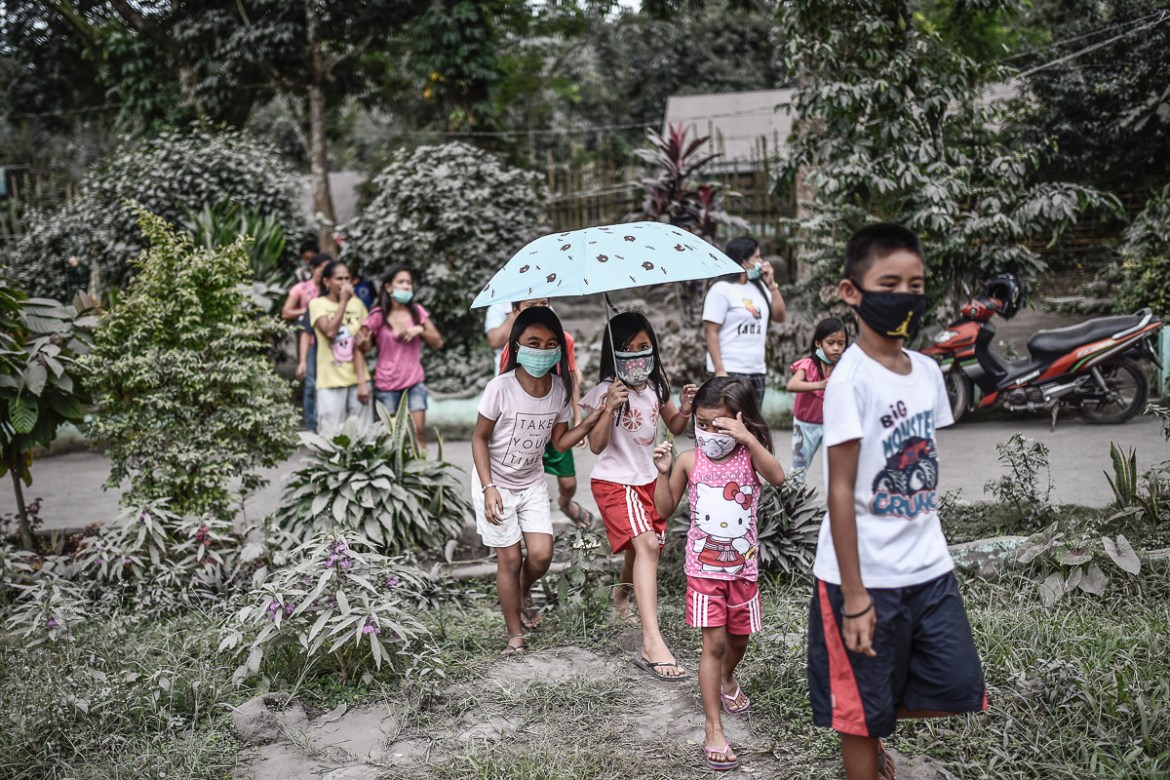 Residents wear face masks amidst heavy ashfall at an evacuation center in Camalig, Albay province, Philippines, January 24, 2018. The entire province of Albay which houses Mayon has been placed under