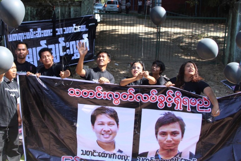 Journalists take part in a protest outside the court where Reuters journalists Wa Lone and Kyaw Soe Oo attend a hearing in Yangon
