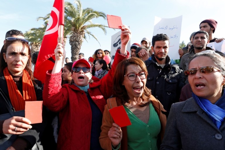 Protesters shout slogans during protests against rising prices and tax increases, in Tunis