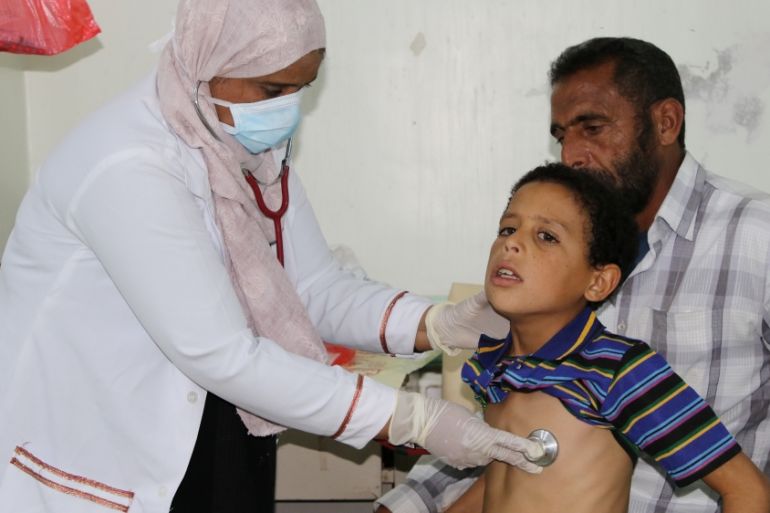 Nahla Arishi, a pediatrician, checks a boy infected with diphtheria at the al-Sadaqa teaching hospital in the southern port city of Aden