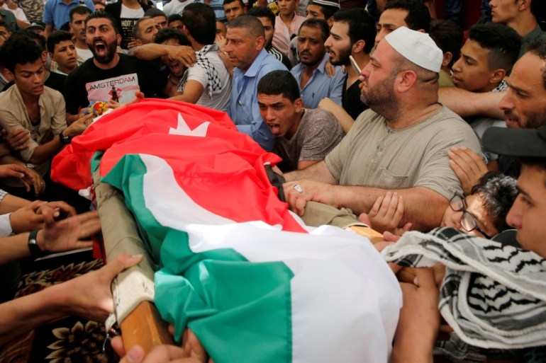 FILE PHOTO: People attend the funeral of Mohammad Jawawdah in Amman