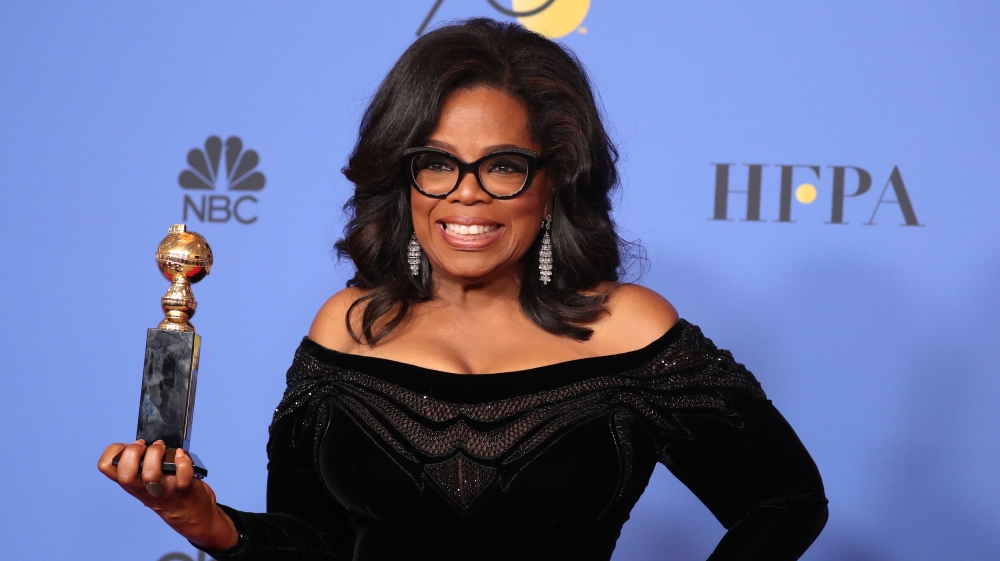 Oprah Winfrey poses backstage with her Cecil B DeMille Award [Lucy Nicholson/Reuters] 