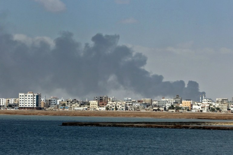 Smoke billowing from a military camp in Yemen''s coastal city of Aden after a UAE air strike
