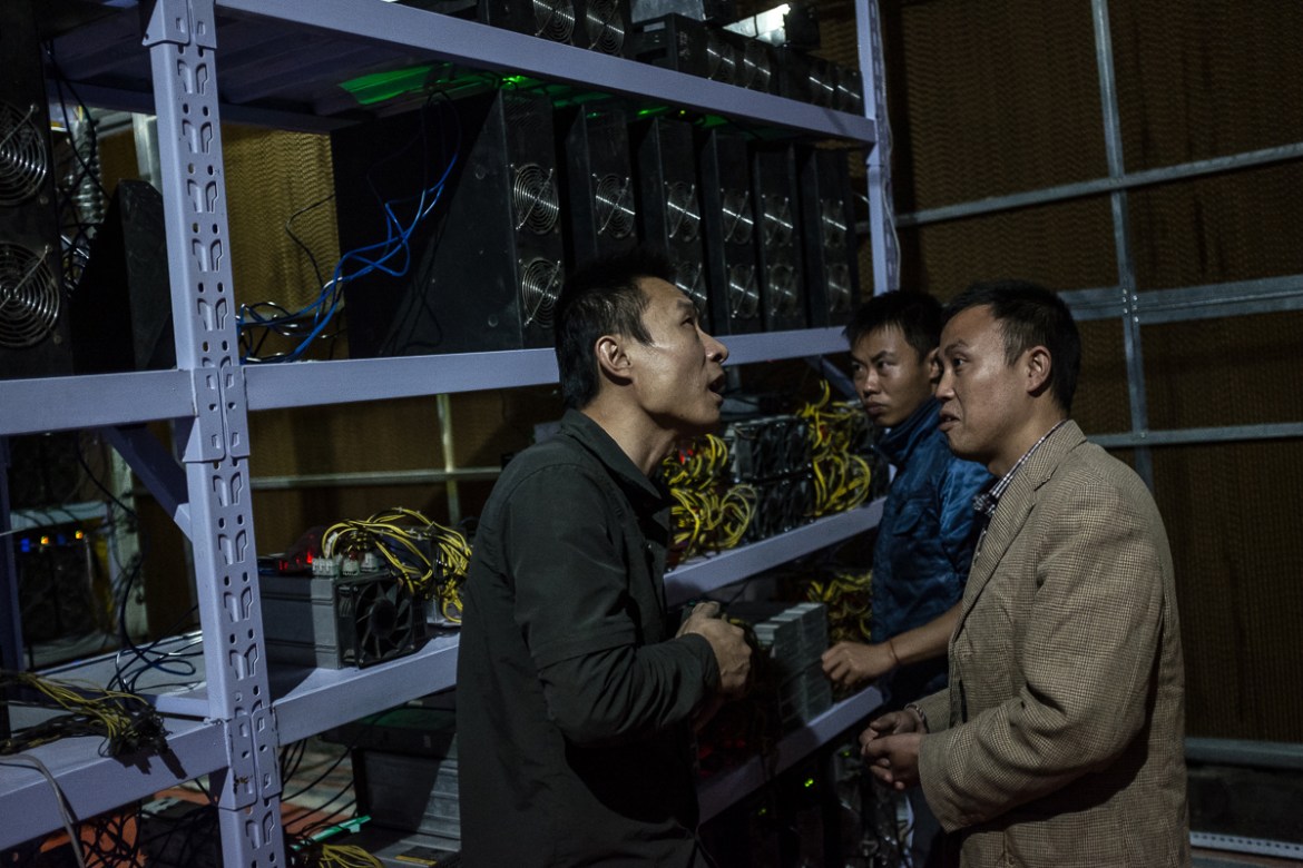 Bitcoin miner Liu (L) meets with clients at his mine in Sichuan Province, China, 27 September 2016. He moved from Henan province to Sichuan province in 2015 for the cheaper electricity. Now, he manage