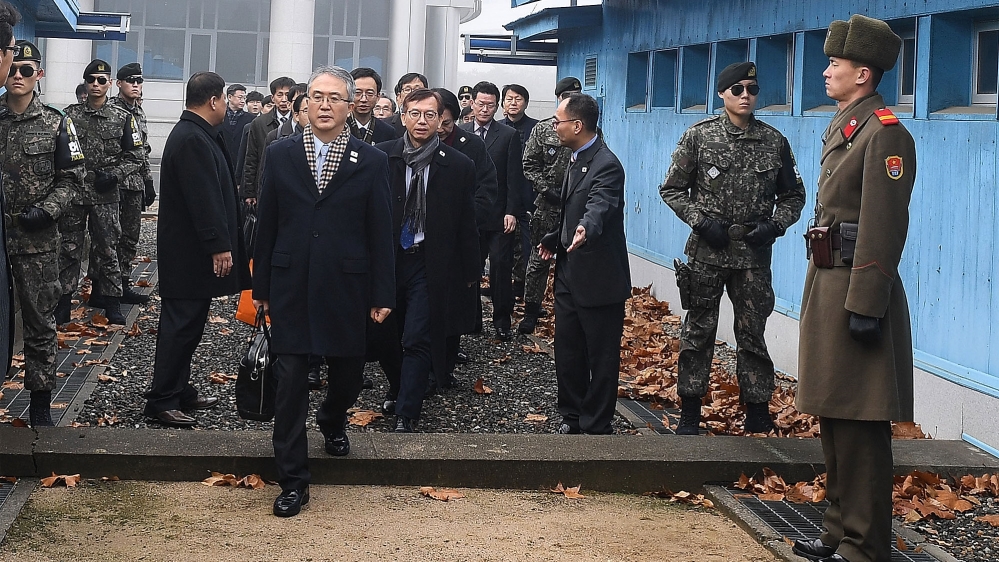 South Korean representatives cross to the North Korean side of the border on Monday [Getty Images]