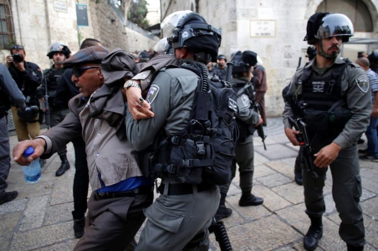 Israeli security personnel clash with a Palestinian protester during a demonstration in Jerusalem''s old city